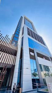 two people sitting in front of a tall building at Luxury Studio Apartment Palm View with Big Balcony Free Parking by Belvilla in Dubai +25 photos