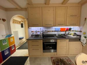 a kitchen with wooden cabinets and a sink at Love Mountain House in Campestrin +61 photos
