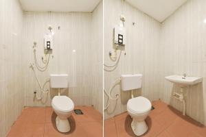 a bathroom with two toilets and a sink at Hotel O Gest Inn in Kota Tinggi