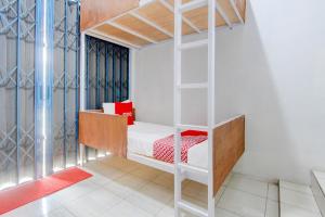 a bedroom with a bunk bed with a ladder at Hotel O Wonosobo Bunkbed in Wonosobo +24 photos