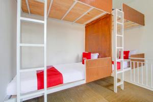 a bedroom with two bunk beds and a staircase at Hotel O Wonosobo Bunkbed in Wonosobo