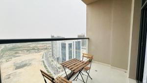 a balcony with two chairs and a view of a city at Spacious Studio Apartment Palm View with Big Balcony Free Parking by Belvilla in Dubai