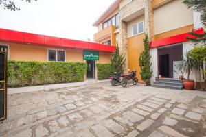 a motorcycle parked in front of a building at OYO 817 Hotel Garden Flower in Kathmandu