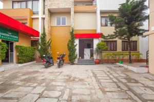 a motorcycle parked in front of a building at OYO 817 Hotel Garden Flower in Kathmandu