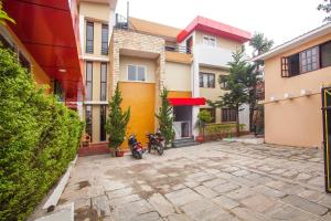 a couple of motorcycles parked in front of a building at OYO 817 Hotel Garden Flower in Kathmandu