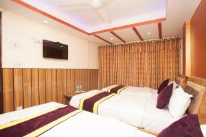 OYO 814 Machhapuchhre Hotel房間的床