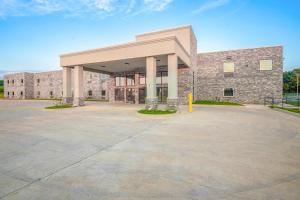a large building with a parking lot in front of it at OYO Hotel Adairsville Calhoun South I-75 in Adairsville