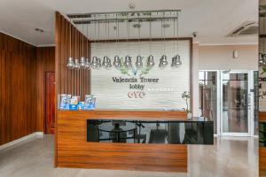 a shop with a counter with a sign on the wall at OYO 94010 Victoria Square in Kandang-besar