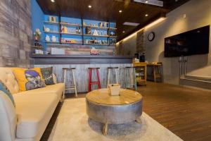 a living room with a couch and a bar at Book 5 in Dongshan