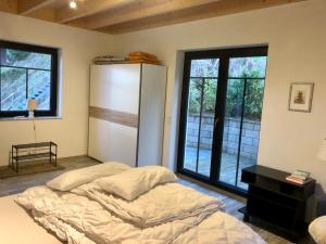 a bedroom with a bed and a large window at Rabenlay in Oberneisen