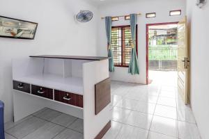 a kitchen with a white counter and a door at Hotel O Rafie Exclusive 2 Syariah in Jambi +23 photos