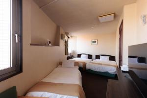 Postel nebo postele na pokoji v ubytování Hotel Honjo