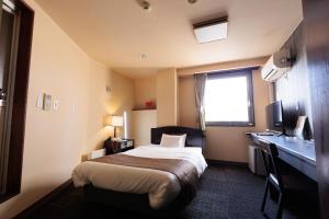 Postel nebo postele na pokoji v ubytování Hotel Honjo