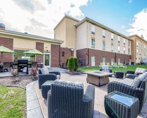 a patio with chairs and a table in front of a building at Comfort Suites Marietta-Parkersburg in Marietta