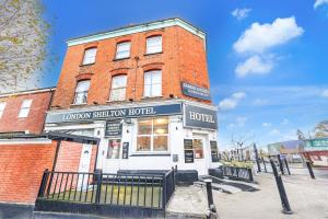 a brick building with a sign that reads london station hotel at London Shelton Hotel, Finsbury Park in London