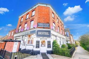 a large brick building with a hotel sign on it at London Shelton Hotel, Finsbury Park in London