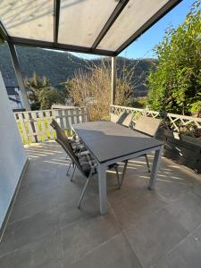 a table and chairs sitting on a patio at Ferienhaus Leopold mit Burgblick an der Mosel in Burgen