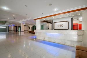 a lobby of a hotel with a reception desk at Collection O Senapelan Near Rsud Petala Bumi Formerly De Town Hotel in Pekanbaru