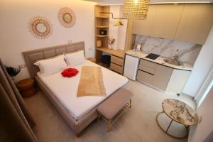 a small bedroom with a bed and a kitchen at Vila Murati in Ksamil