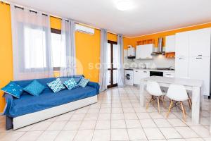 a living room with a blue couch and a table at Alice Flat - SAN FOCA in San Foca