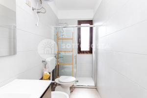a white bathroom with a toilet and a shower at Alice Flat - SAN FOCA in San Foca +21 photos