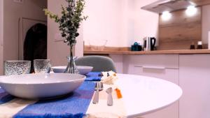 a table with a white bowl and a blue table cloth at Apartamentos Lydia by gaiarooms in León