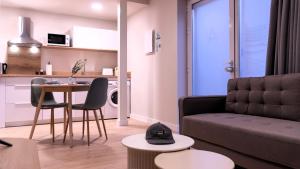 a living room with a couch and a table at Apartamentos Lydia by gaiarooms in León