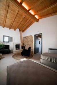 a bedroom with a bed and a living room at Masseria Casina Fiocca in Pisignano