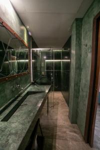 a bathroom with a large sink and a shower at Hotel Boutique Patio del Posadero in Córdoba