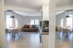 a living room with a couch and a table and chairs at Ъгловата къща in Lovech