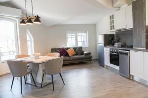 a kitchen and living room with a table and a couch at Ъгловата къща in Lovech