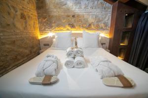 a hotel room with a bed with towels on it at Hotel Boutique Patio del Posadero in Córdoba