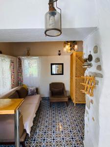 a living room with a couch and a table at Badehan Guest House in Cesme