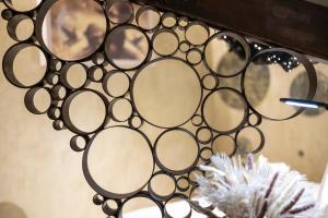 a bunch of glasses hanging on a wall at Hotel Boutique Patio del Posadero in Córdoba