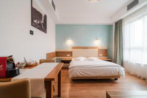 a bedroom with a bed and a desk and a bed sidx sidx sidx at Tci Social Club in Cluj-Napoca +32 photos