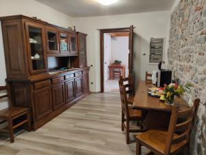 a dining room with a wooden table and chairs at Casa Beuzer in Cividale del Friuli