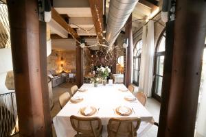 a dining room with a long table and chairs at Hotel Boutique Patio del Posadero in Córdoba