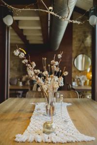 a vase with flowers in it on a table at Hotel Boutique Patio del Posadero in Córdoba
