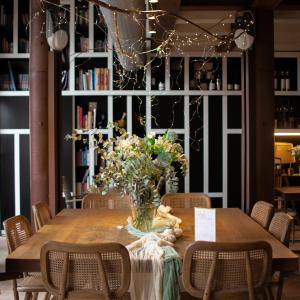 a table with a vase of flowers and lights at Hotel Boutique Patio del Posadero in Córdoba
