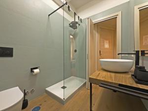 a bathroom with a sink and a glass shower at Vatican Dolce Remy Guest House - Metro Cipro in Rome