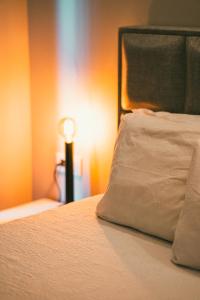 a bed with a pillow and a lamp in a room at Kleopatra City II in Alanya +18 photos