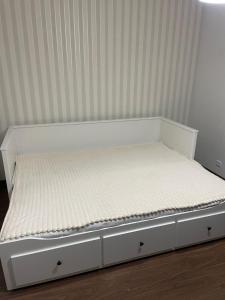 a bed with a white bed frame in a room at Green Pine in Leiria +3 photos