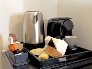 a tray of food on a counter with a coffee maker at Vatican Dolce Remy Guest House - Metro Cipro in Rome