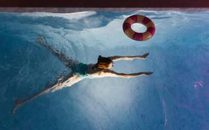 a person swimming in a pool with a ball at Casa Mila Loire - L'expérience Hôtel & Spa - Angers Saumur in Saint-Mathurin +115 photos