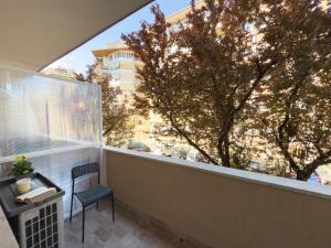 a balcony with a chair and a large window at Vatican Dolce Remy Guest House - Metro Cipro in Rome