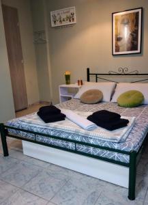 a bed with two pillows on top of it at Daisy in Nafplio