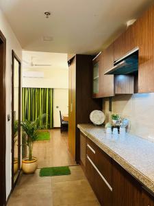 a kitchen with wooden cabinets and a counter top at Your 2nd Home Studio Haven in Dehradun +11 photos