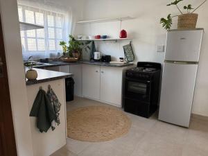 a kitchen with a white refrigerator and a stove at Wittus Retreat in White River