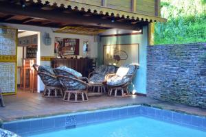 a group of chairs sitting next to a swimming pool at Hotel Les Boucaniers in Ambatoloaka +40 photos