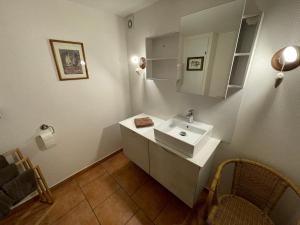 a bathroom with a white sink and a mirror at Apartment Cali Elina in Riquewihr +35 photos